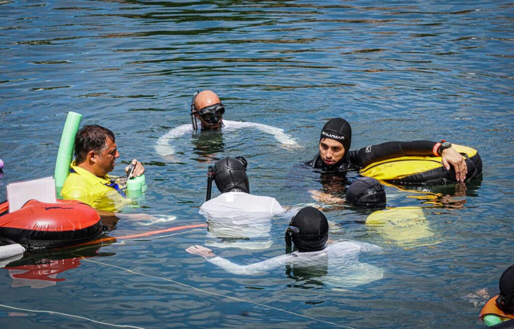 Freediving safety team briefing at the surface during a training session