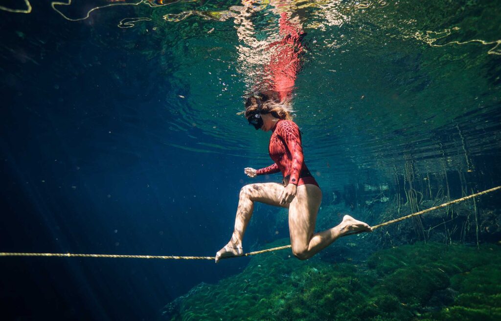 Freediver balancing on a line during an underwater photoshoot